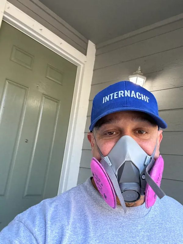 Real FMT inspector — respirator + pink P100 + INTERNACHI cap